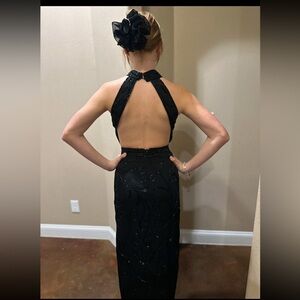 Long Black beaded Dress with open back, choker-collared neck and side slit.